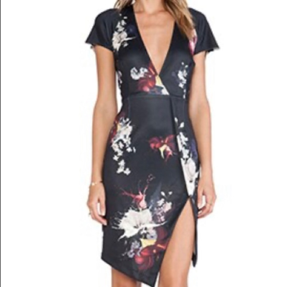 Ringuet cap sleeve dress with low cut front. Floral print and side slit.